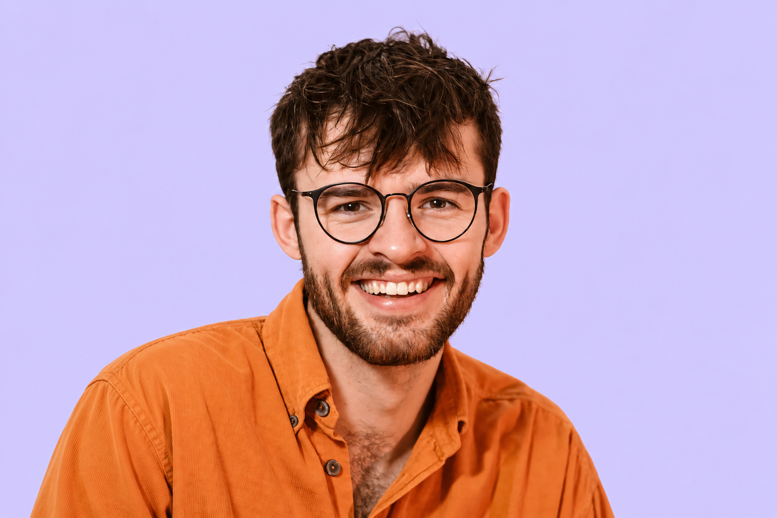 Morgan smiling, wearing glasses and an orange shirt.